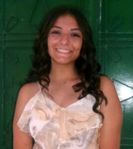 Flower girl smiling at the Tarpon Springs Sponge Docks, Florida.